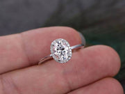 Oval cut Moissanite and Diamond Halo Engagement Ring in 10k Rose Gold

