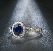 2 Carat oval cut Blue Sapphire and Moissanite Halo Engagement Ring in White Gold