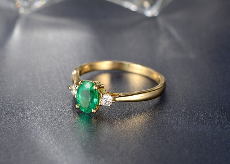 Trilogy Half Carat oval cut Emerald and Round Moissanite Diamond Engagement Ring in Yellow Gold