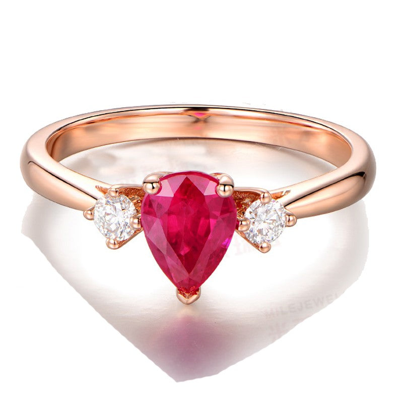 Trilogy Half Carat Pear Shape Ruby and Round Moissanite Diamond Engagement Ring in Rose Gold